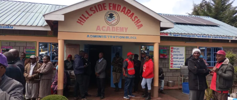 Parents outside the administration block at Endarasha Academy.